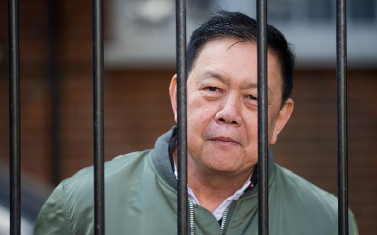 Former Myanmar Ambassador Kyaw Zwar Minn speaks to media through the locked gates of his official residence on the day he is set to be evicted.  - Jamie Lorriman for The Telegraph