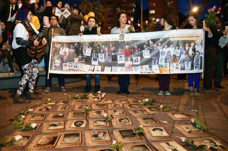 Photos of missing people are displayed during an event in which Colombians celebrate in Bogota as they watch the signing of the agreement at the conclusion of the peace talks in Havana on August 24, 2016