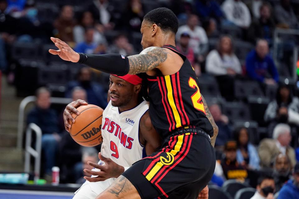 Detroit Pistons forward Jerami Grant (9) runs into Atlanta Hawks forward John Collins (20) during the first half of an NBA basketball game, Monday, March 7, 2022, in Detroit.