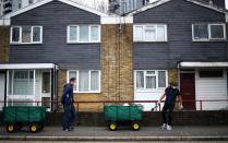 Volunteers cart food donations from a local food bank through the Carpenters Estate in Stratford, as the spread of the coronavirus disease (COVID-19) continues, in east London