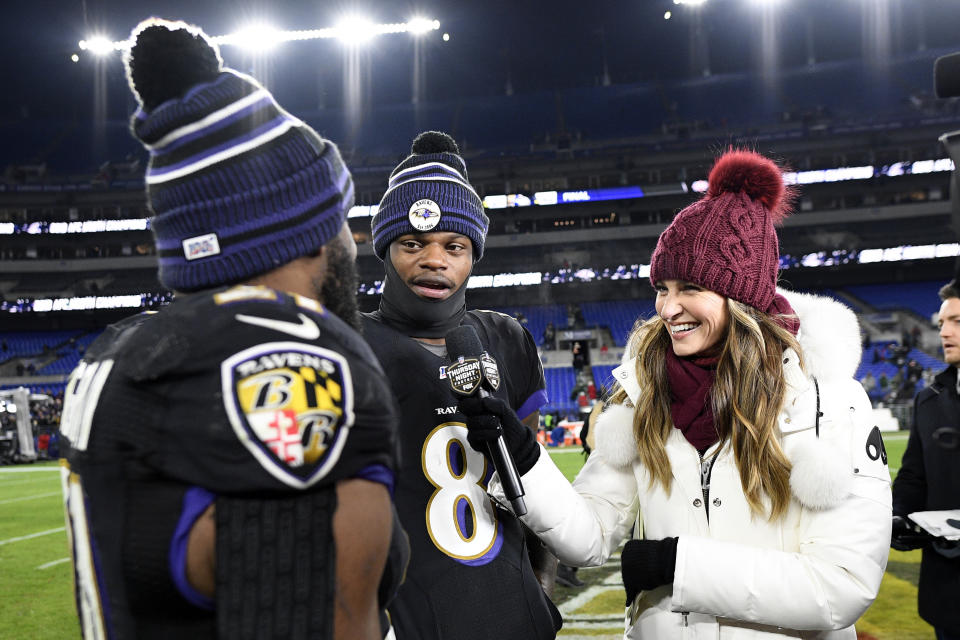 Baltimore Ravens running back Mark Ingram, left, pretends to interview quarterback Lamar Jackson (8) while standing with Fox sideline reporter Erin Andrews after an NFL football game against the New York Jets, Thursday, Dec. 12, 2019, in Baltimore. The Ravens won 42-21. (AP Photo/Nick Wass)
