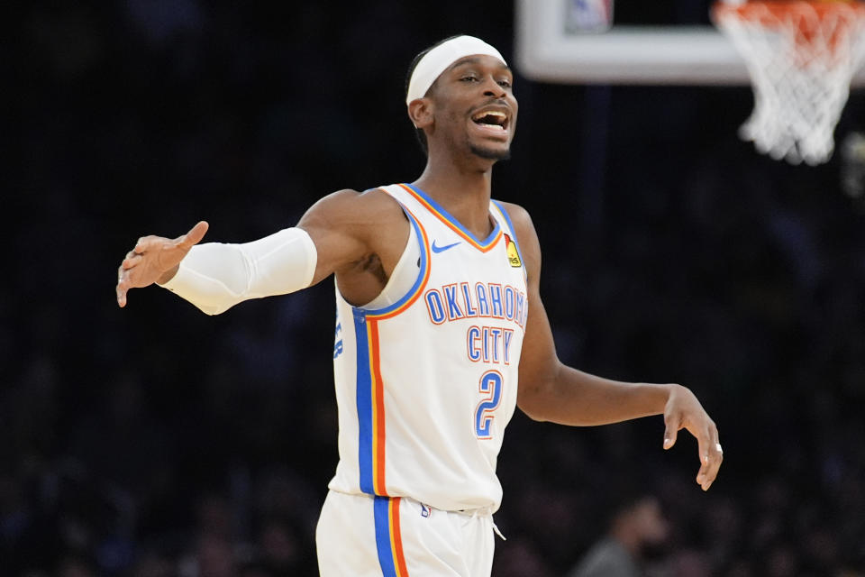 Oklahoma City Thunder guard Shai Gilgeous-Alexander reacts after a 3-point basket by guard Luguentz Dort during the first half of an NBA basketball game against the Los Angeles Lakers, Monday, March 4, 2024, in Los Angeles. (AP Photo/Marcio Jose Sanchez)