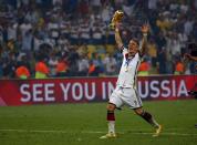 Germany's Bastian Schweinsteiger holds the World Cup trophy as he celebrates their 2014 World Cup final win against Argentina at the Maracana stadium in Rio de Janeiro July 13, 2014. REUTERS/Michael Dalder (BRAZIL - Tags: SOCCER SPORT WORLD CUP TPX IMAGES OF THE DAY)