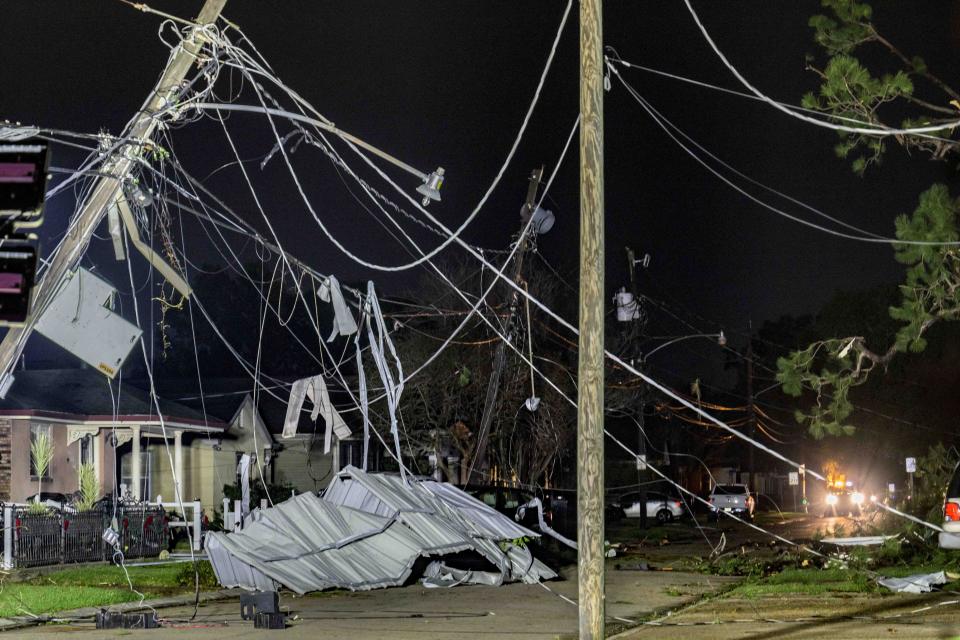 Power lines and metal roofing are seen in a tornado damaged neighborhood in Gretna, La., in Jefferson Parish neighboring New Orleans, Wednesday, Dec. 14, 2022. AP Photo/Matthew Hinton)