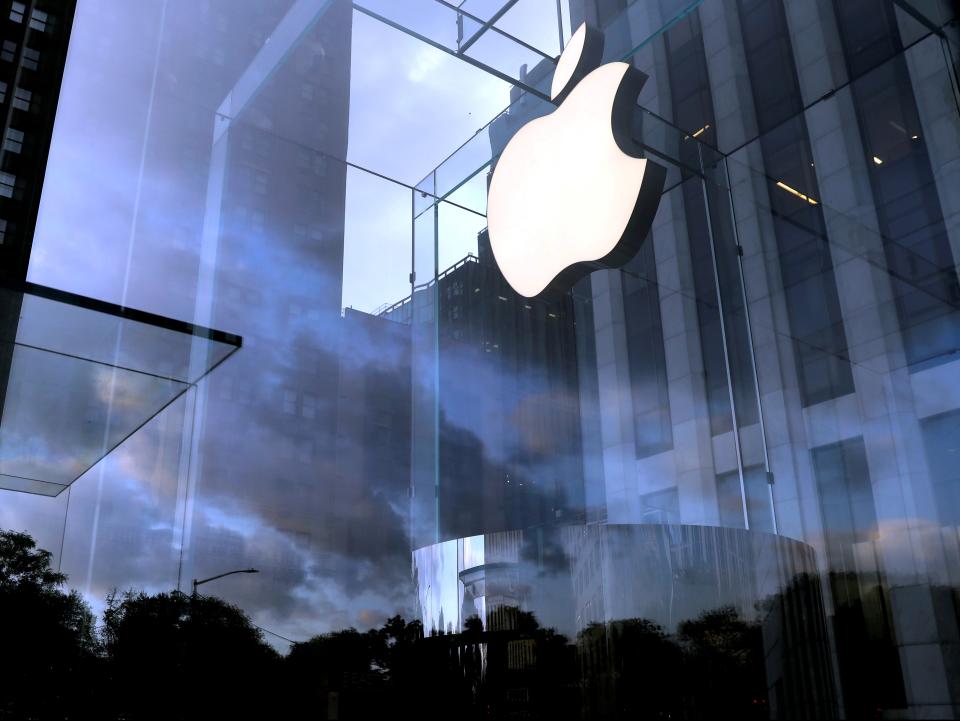 The Apple Inc. logo is seen hanging at the entrance to the Apple store on 5th Avenue in Manhattan, New York (REUTERS)