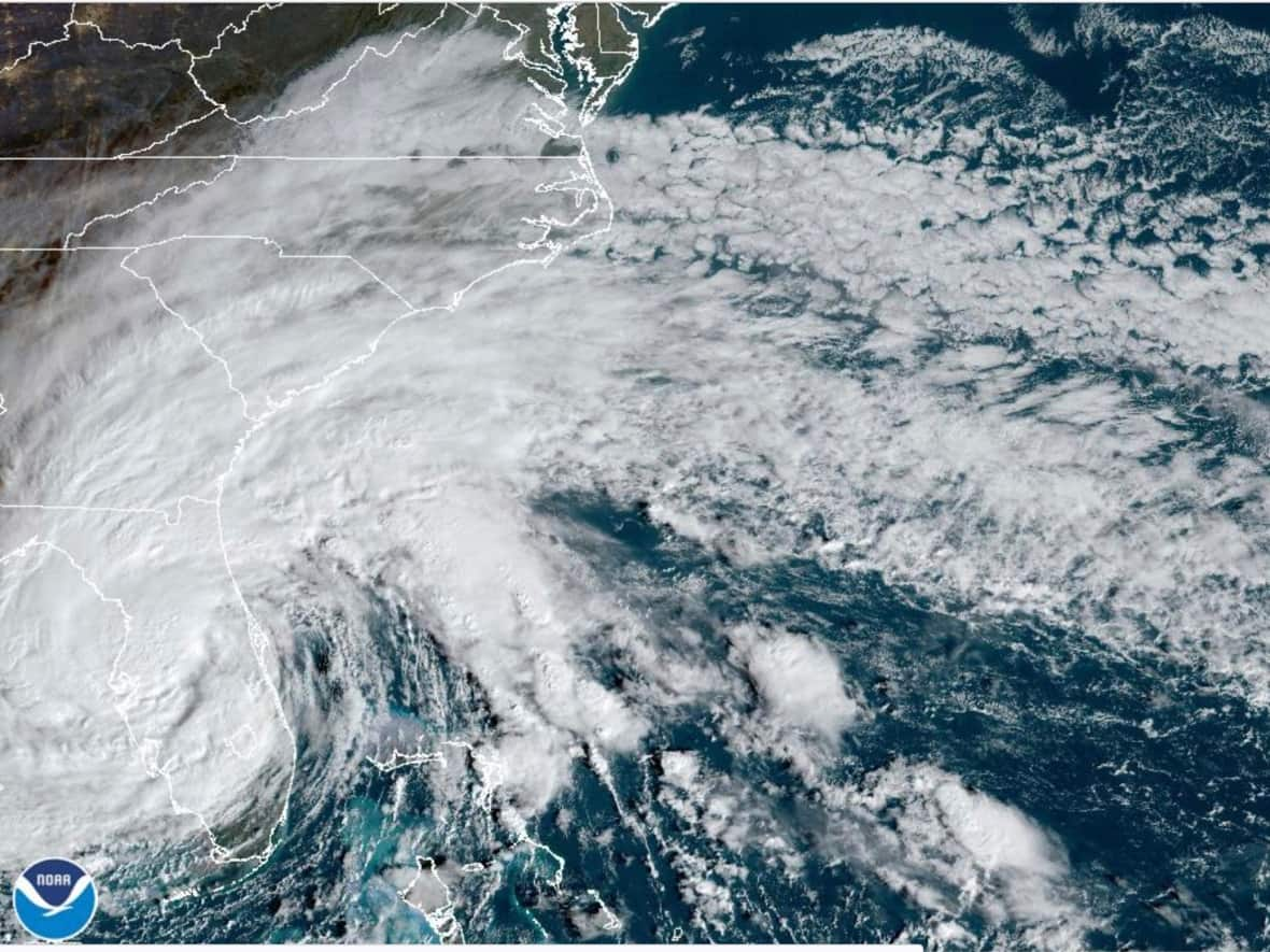 This satellite image provided by NOAA shows tropical storm Nicole making landfall as a hurricane early Nov. 10, 2022 near Florida. It's such a sprawling storm that it has covered nearly the entire peninsula while reaching into Georgia and South Carolina. (NOAA/The Associated Press - image credit)