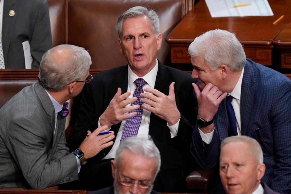 Reps. Patrick McHenry, R-N.C., left, and Rep. Tom Emmer, R-Minn., speak Wednesday with Rep. Kevin McCarthy, R-Calif., in the House chamber as McCarthy sought for a second day to be elected House speaker.