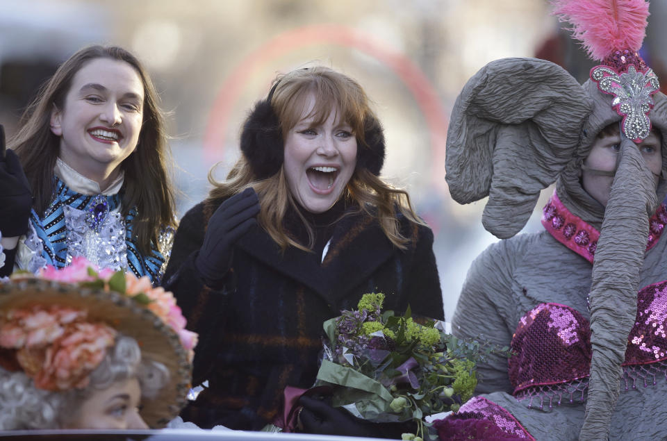 Actor Bryce Dallas Howard, center, Hasty Pudding Woman of the Year, rides in a convertible with Harvard University theatrical students Grace Ramsey, left, and David Lynch, right, during a parade, Thursday, Jan. 31, 2019 through Harvard Square, in Cambridge, Mass. The award was presented to Howard by Hasty Pudding Theatricals, a theatrical student society at Harvard University. (AP Photo/Steven Senne)
