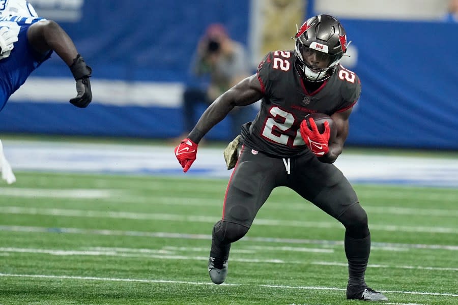 Tampa Bay Buccaneers running back Chase Edmonds (22) runs the ball during the first half of an NFL football game against the Indianapolis Colts Sunday, Nov. 26, 2023, in Indianapolis. (AP Photo/Darron Cummings)