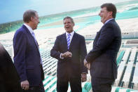 Tennessee Gov. Bill Lee, center, talks with Ford Executive Chairman Bill Ford, left, and Jim Farley, Ford president and CEO, right, after a presentation on the planned factory to build electric F-Series trucks and the batteries to power future electric Ford and Lincoln vehicles Tuesday, Sept. 28, 2021, in Memphis, Tenn. The plant in Tennessee is to be built near Stanton, Tenn. (AP Photo/Mark Humphrey)