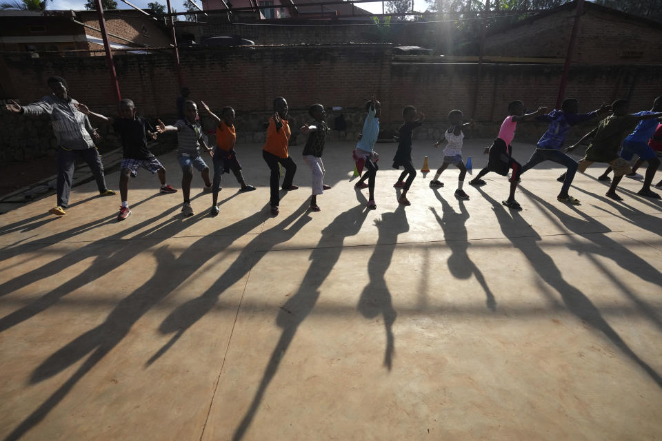 Children practise fencing game, on the outskirts of Kigali, Rwanda, Tuesday, April 4, 2024. The country will commemorate on April 7, 2024 the 30th anniversary of the genocide when ethnic Hutu extremists killed neighbours, friends and family during a three-month rampage of violence aimed at ethnic Tutsis and some moderate Hutus, leaving a death toll that Rwanda puts at 1,000,050. (AP Photo/Brian Inganga)