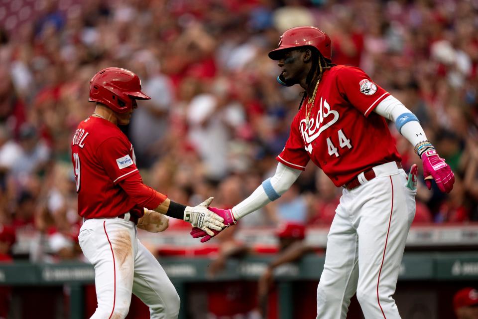 Reds left fielder TJ Friedl high fives shortstop Elly De La Cruz (44) after scoring off of a Matt McLain double in the first inning against the Cleveland Guardians at Great American Ball Park on Wednesday, Aug. 16, 2023.