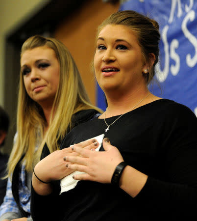 Laura Grillot (R) and her sister Maggie talk about their brother Ian Grillot, who was shot trying to stop a gunman who killed Indian engineer Srinivas Kuchibhotla at a local bar, during a vigil at a conference center in Olathe, Kansas, U.S., February 26, 2017. REUTERS/Dave Kaup