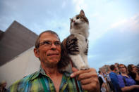 Leroy Bergstrom of Maple Plain, Minn. arrives with his cat Maestro before the Walker Art Center's first "Internet Cat Video Film Festival," showcasing the best of cat films on the Internet in Minneapolis Thursday Aug. 30, 2012. The Walker Art Center in Minneapolis held its first-ever online cat video festival, a compilation of silly cat clips that have become an Internet phenomenon, attracting millions of viewers for some of the videos. (AP Photo/Craig Lassig)