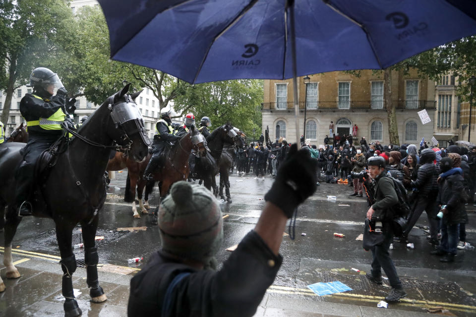 Mounted police faces demonstrators after scuffles during a Black Lives Matter march in London, Saturday, June 6, 2020, as people protest against the killing of George Floyd by police officers in Minneapolis, USA. Floyd, a black man, died after he was restrained by Minneapolis police while in custody on May 25 in Minnesota. (AP Photo/Frank Augstein)