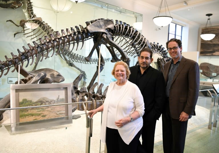 From L to R: Rhoda Knight Kalt, composer John Musto and librettist Eric Einhorn pose at the Dinosaur Hall of the American Museum of Natural History