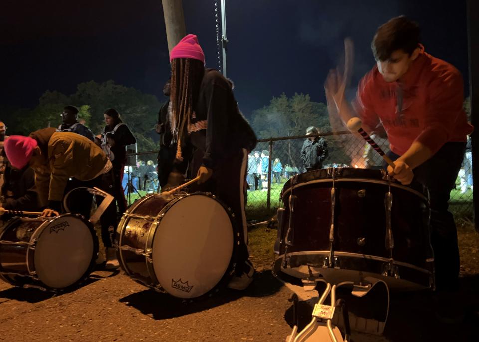 Members of the high school drum line perform after the game.