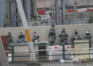 Police guard the perimeter of Hong Kong Polytechnic University (PolyU) in Hong Kong