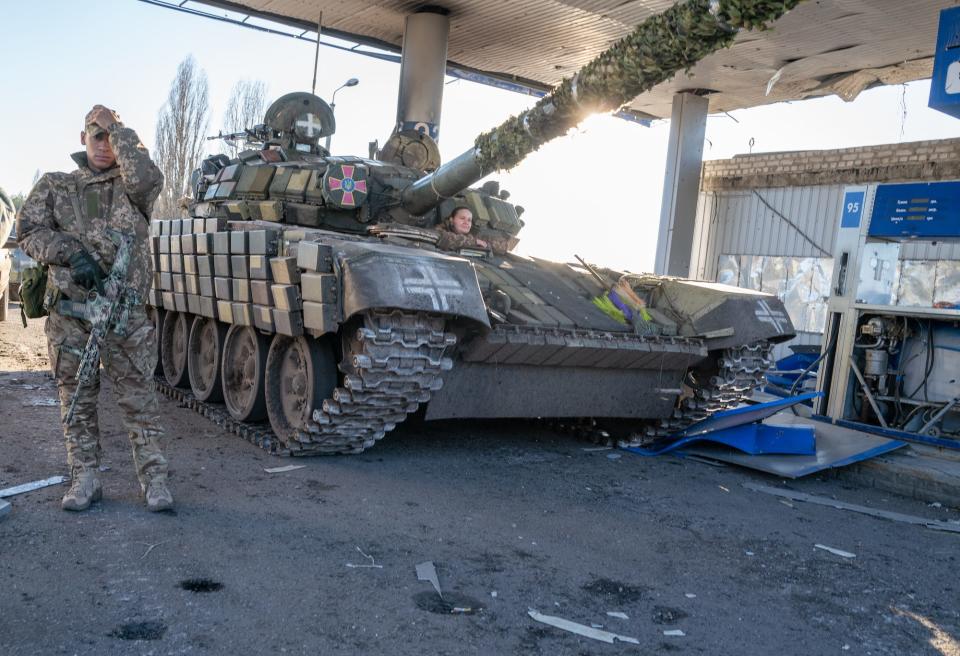 Ukrainian soldiers work on a tank in Kharkiv