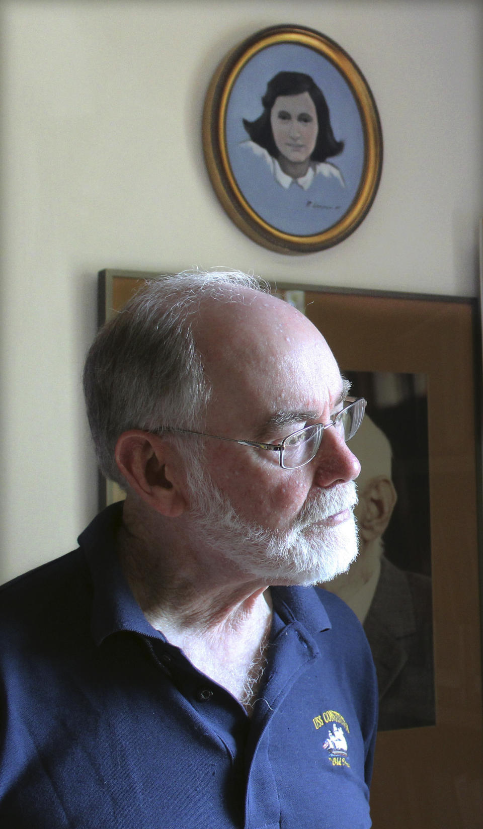 In this June 7, 2019 photo, Ryan Cooper stands next to his painting of the famed Holocaust victim and diarist Anne Frank, at his home in Yarmouth, Mass. Cooper, a local artist, has donated a trove of letters and mementos he received from her father, Otto Frank, to the U.S. Holocaust Memorial Museum ahead of the 90th anniversary of Anne Frank's birthday. (AP Photo/Philip Marcelo)