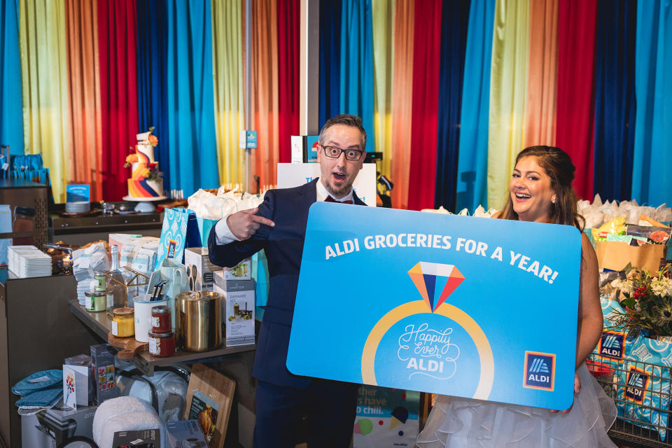 Mike and Jessica Hurd posing with their free grocery prize. (Courtesy Fig Media)