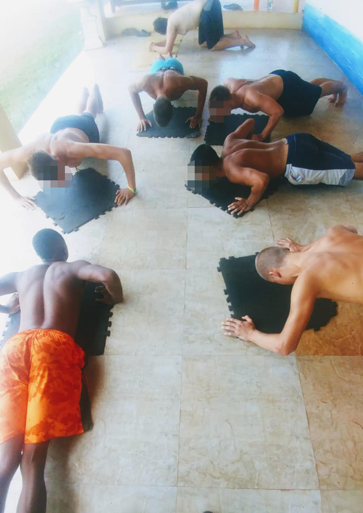 Boys do pushups at Atlantis Leadership Academy. Faces have been obscured by NBC News. (Obtained by NBC News)