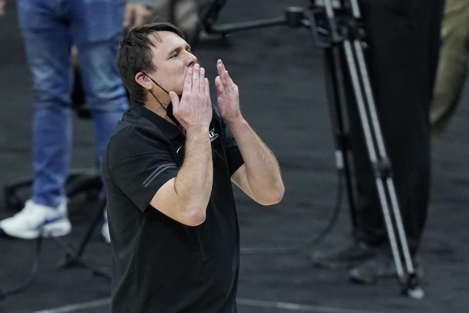 Abilene Christian head coach Joe Golding blows kisses to the crowd after Abilene Christian upset Texas in a college basketball game in the first round of the NCAA tournament at Lucas Oil Stadium in Indianapolis Sunday, March 21, 2021. Abilene Christian won 53-52. (AP Photo/Mark Humphrey)