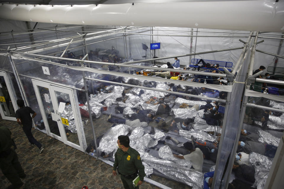 FILE - Children lie inside a pod at the main detention center for unaccompanied children in the Rio Grande Valley run by U.S. Customs and Border Protection (CBP), in Donna, Texas, March 30, 2021. (AP Photo/Dario Lopez-Mills, Pool, File)