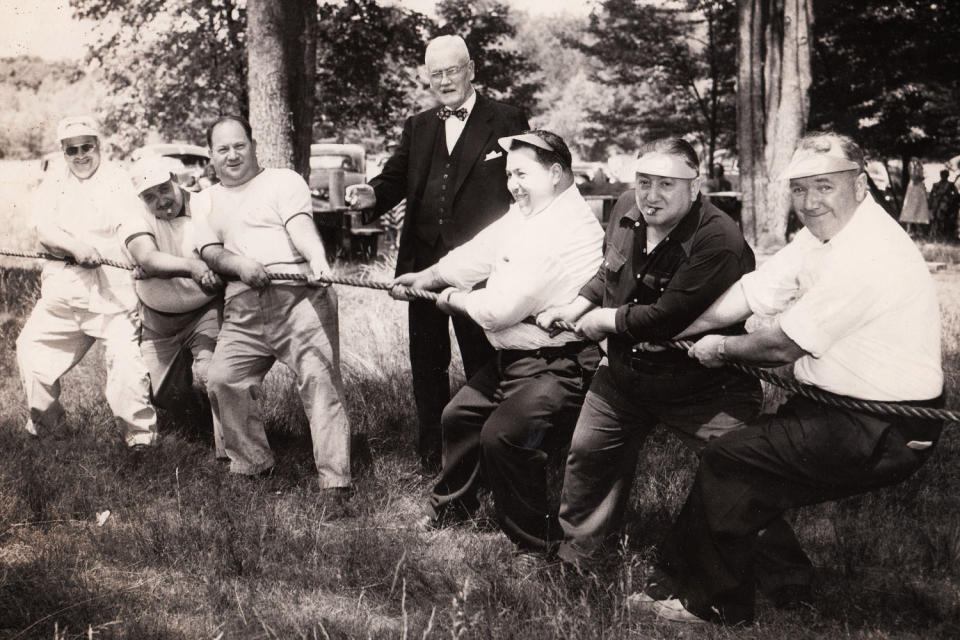 <div class="cell medium-auto caption"> Tug of war at the summer outing of a Massachusetts Fat Men’s Club in 1951</div> <div class="cell medium-shrink medium-text-right credit">Harry Bagan Photographs, Cambridge Historical Commission</div>