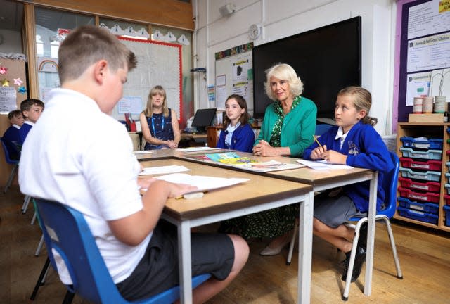 The Queen listens as a pupil reads a poem they have written (Hollie Adams/PA)