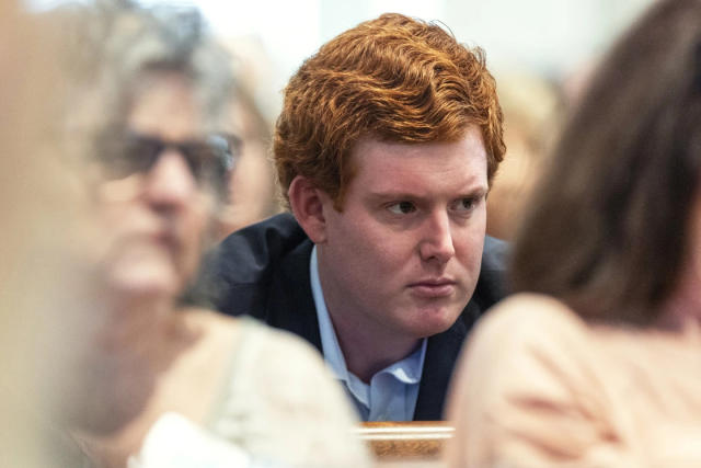 Buster Murdaugh, right, the son of Alex Murdaugh, listens to a