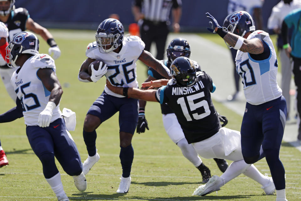 Tennessee Titans cornerback Kristian Fulton (26) runs back an interception as Jacksonville Jaguars quarterback Gardner Minshew (15) tries to tackle him in the first half of an NFL football game Sunday, Sept. 20, 2020, in Nashville, Tenn. (AP Photo/Wade Payne)