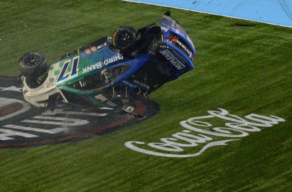 NASCAR drivers Chris Bueschers (17) car begins to flip after he and driver Daniel Suarez (99), wrecked after crossing the start/finish line during the Coca-Cola 600 at Charlotte Motor Speedway on Sunday, May 29, 2022. Buescher would flip down the front stretch before coming to rest on the roof of the car. JEFF SINER/jsiner@charlotteobserver.com