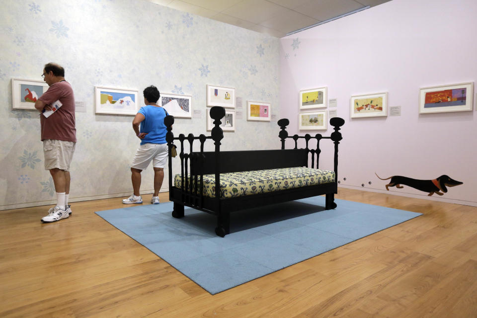 In this Friday, July 19, 2013 photo, visitors view illustrations at The Snowy Day and The Art Of Ezra Jack Keats exhibition at the National Museum of American Jewish History, in Philadelphia. The exhibit opened July 19. (AP Photo/Matt Rourke)