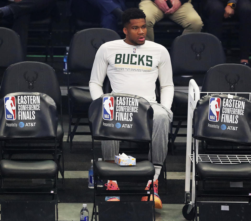 Injured Milwaukee Bucks forward Giannis Antetokounmpo watches from the bench as his team takes on the Atlanta Hawks in Game 5 of the Eastern Conference finals in the NBA basketball playoffs Thursday, July 1, 2021, in Milwaukee. (Curtis Compton/Atlanta Journal-Constitution via AP)