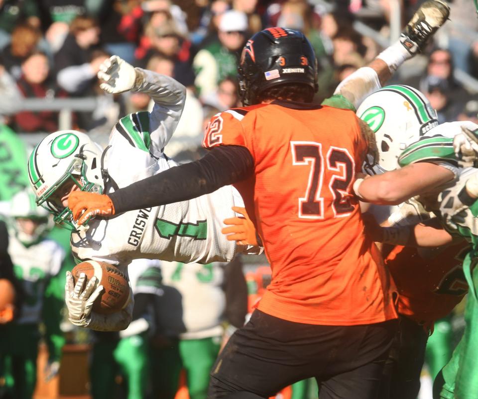 Griswold/Wheeler's KinKade Rubino gets some air and yardage on Plainfield's Cole Cheney Thanksgiving day during Griswold/Wheeler's 36-0 win in Plainfield.