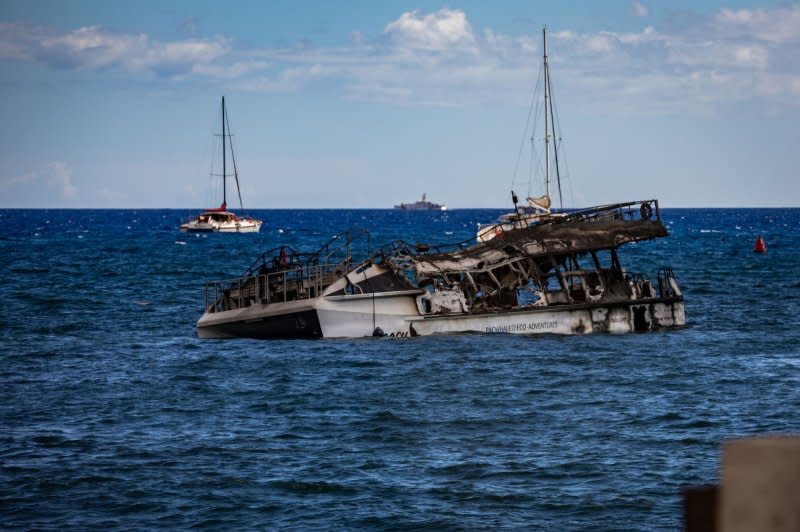 A damaged PacWhale Eco-Adventures Catamaran sits off the shore in Lahaina, Maui, on Wednesday. Photo by Staff Sgt. Matthew A. Foster/U.S. Army National Guard/UPI