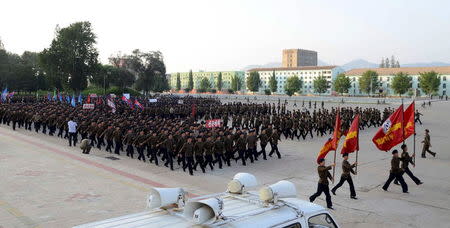 North Koreans who signed up to join the army march in the midst of political tension with South Korea, in this undated photo released by North Korea's Korean Central News Agency (KCNA) in Pyongyang August 23, 2015. REUTERS/KCNA