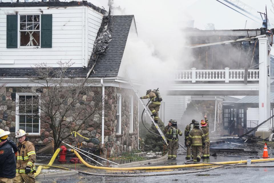 Firefighters from multiple departments work on putting out a fire at Oakland Hills Country Club in Bloomfield Township on Thursday, Feb. 17, 2022.