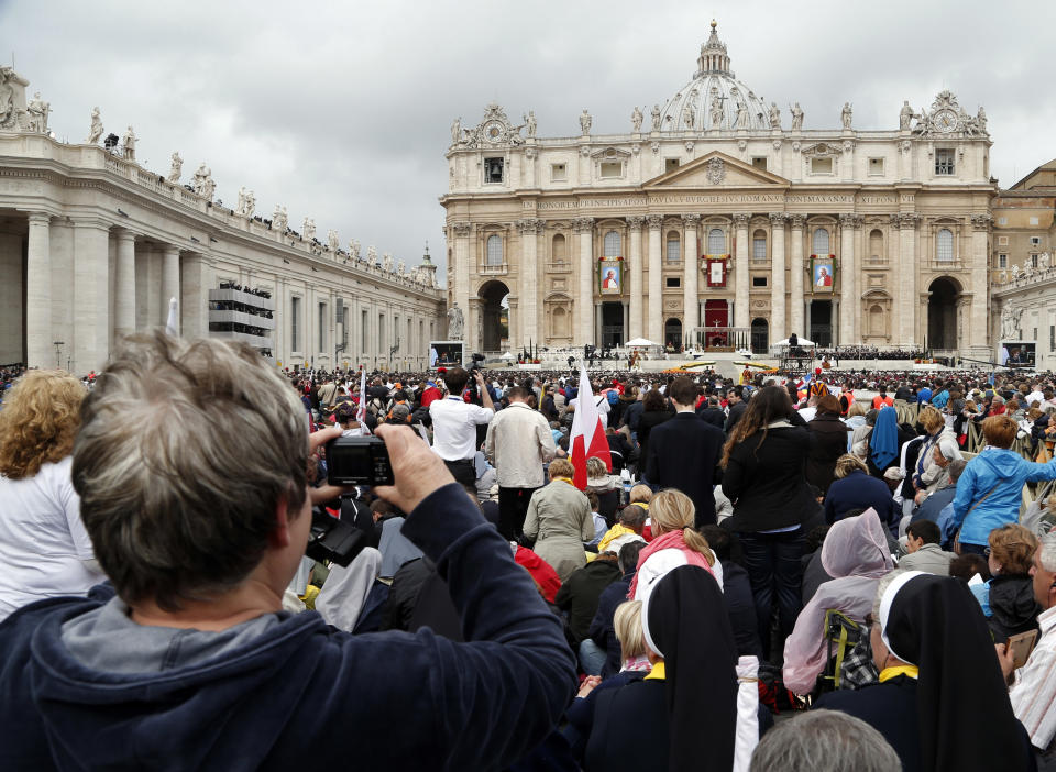 Faithful fill St. Peter's Square during a solemn ceremony led by Pope Francis, at the Vatican, Sunday, April 27, 2014. Pope Francis has declared his two predecessors John XXIII and John Paul II saints in an unprecedented canonization ceremony made even more historic by the presence of retired Pope Benedict XVI. (AP Photo/Domenico Stinellis)