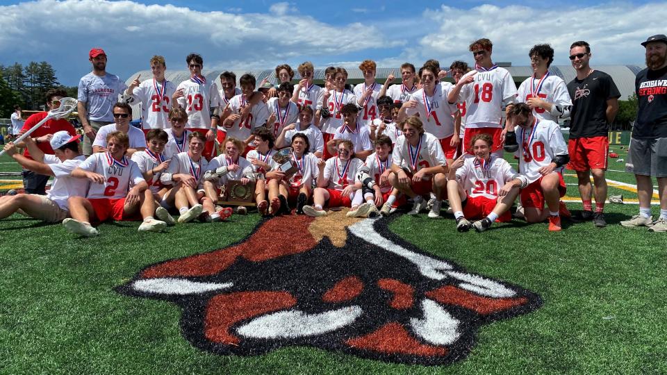 CVU boys lacrosse poses with the championship trophy after winning the D-I crown for the ninth straight year on Saturday at Virtue Field.