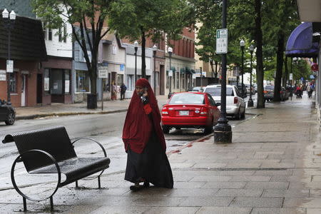 A Somali woman walks along a street in downtown Lewiston, Maine June 1, 2015. REUTERS/Brian Snyder