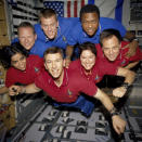 FILE - This undated photo released in June 2003 provided by NASA shows STS-107 crew members aboard the Space Shuttle Columbia. On Feb. 1, 2003, the seven crew members were lost as the Columbia fell apart over East Texas. This picture was on a roll of unprocessed film later recovered by searchers from the debris. From the left (bottom row), wearing red shirts to signify their shift's color, are mission specialist Kalpana Chawla, commander, Rick D. Husband, mission commander Laurel B. Clark and Ilan Ramon, payload specialist. From the left (top row), wearing blue shirts, are mission specialist David M. Brown, pilot William C. McCool, pilot; and payload commander Michael P. Anderson. (NASA via AP, File)