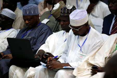 Party agents take notes at the INEC office during the announcemennt of results of the presidential election in Kano, Nigeria February 24, 2019. REUTERS/Afolabi Sotunde