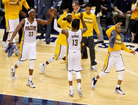 Apr 29, 2016; Indianapolis, IN, USA; Indiana Pacers forward Paul George (13) celebrates with center Myles Turner (33) and guard Ty Lawson (10) against the Toronto Raptors during the second half in game six of the first round of the 2016 NBA Playoffs at Bankers Life Fieldhouse. Mandatory Credit: Brian Spurlock-USA TODAY Sports