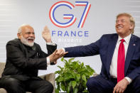 Indian Prime Minister Narendra Modi, left, slaps the hand of President Donald Trump as they share a laugh during a bilateral meeting at the G-7 summit in Biarritz, France, Monday, Aug. 26, 2019. (AP Photo/Andrew Harnik)