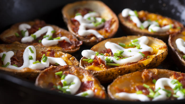 Loaded potato skins in skillet