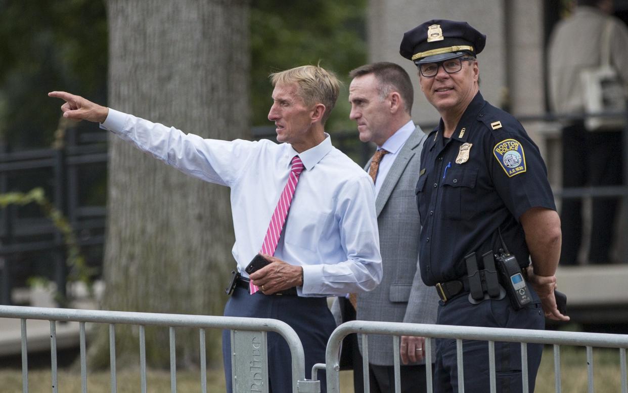 Boston Police Commissioner William Evans, left, with other officers along barricades on the Boston Common on Saturday - Getty Images North America