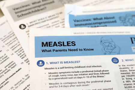 FILE PHOTO: Materials are seen left at demonstration by people opposed to childhood vaccination after officials in Rockland County, a New York City suburb, banned children not vaccinated against measles from public spaces, in West Nyack, New York, U.S. March 28, 2019. REUTERS/Mike Segar/File Photo