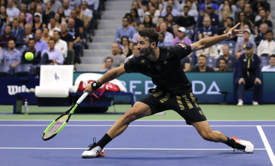 Juan Ignacio Londero, of Argentina, returns to Novak Djokovic, of Serbia, during the second round of the U.S. Open tennis tournament in New York, Wednesday, Aug. 28, 2019. (AP Photo/Charles Krupa)